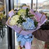 A billowy Pastel Cloud bouquet of mixed-color hydrangeas in blue, pink, lavender