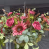 Hanging floral basket with bright pink blooms and eucalyptus