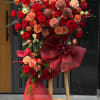 A towering display of deep red roses and warm peach blooms-the Velvet