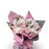 Bouquet of pink and white roses with white tulips wrapped in pink paper