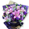 A lush cascade of pink lilies and clustered purple stock makes a