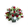 Rich clusters of red roses and pure white lilies create an immediate