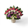 A lush cluster of pink, white, and lavender roses sets the tone