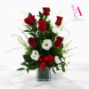 This floral design features 6 stunning red roses paired with white blooms