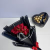 Elegant red roses wrapped in sophisticated black paper and paired with a