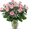 Pink roses and baby's breath in a clear glass vase