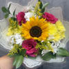 Bursting with cheerful color, this vibrant bouquet features a radiant sunflower, hot