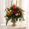 A lush cascade of roses and a bold purple hydrangea create an