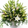 A lush arrangement of Oriental lilies, gladiolus, waxflower, and cascading greenery, beautifully