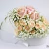 Bouquet of pale pink roses and baby's breath in a white box