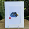 White greeting card with a small cross-stitch fish and red heart