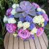 Bouquet of pink and white roses with a purple succulent centerpiece