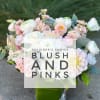 Blush and white mixed bouquet in a square glass vase