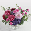 Two large pink roses set the tone in this Magenta Magic bouquet-an