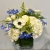 Crisp white hydrangea clusters and a single striking white anemone with its