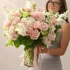 A vase arrangement designed in soft pink tones with a light, balanced