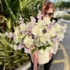 Creamy white roses and lush hydrangeas take center stage in this large