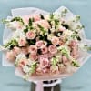 A cloud of pale pink roses takes center stage in this hand-tied