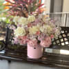 A cloud of cream, blush and lavender blooms arrives tucked into a