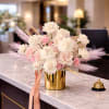 A soft cloud of cream, blush-pink, yellow and peach blooms sits atop