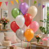 Cluster of colorful balloons in a decorated living room with a birthday cake and gifts