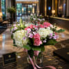 A lush, garden-style bouquet of white and pale green hydrangeas with ruffled