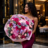 A lush cascade of hot pink roses and soft pink hydrangea anchored