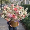 Overflowing with soft pastels, this large flower arrangement-perfect as a birthday bouquet