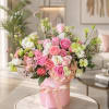 A full, rounded pink hatbox of soft garden charm-this flower arrangement is