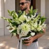 Pure white lilies and lush hydrangea clusters take center stage in this