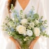 12&rdquo; tall. Creamy white roses and airy blue delphinium-like. The pale palette