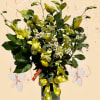 An exotic design of yellow orchids mixed with yellow tulips, accented with