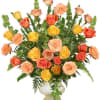 Mixed roses in peach, yellow, and coral in a white vase