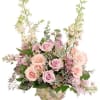 Basket arrangement of pink roses and lavender flowers
