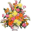 Colorful mixed flower arrangement in a white vase
