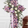 A large, dignified standing cross arrangement that immediately reads as a peaceful