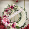 Large floral wreath with pink and white flowers on an easel