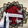 Bouquet of red roses with a white ribbon and butterfly decorations