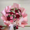 Pink and red rose bouquet with carnations wrapped in pink paper