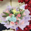 Pastel bouquet with roses, hydrangea, and a small plush toy in a hat