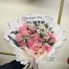 Pink rose bouquet with white baby's breath and paper wrapping