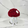 Round bouquet of red roses in a white hat box with white orchids