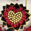 Heart-shaped bouquet of red roses and gold-wrapped chocolates