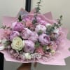 Pink bouquet of peonies and roses wrapped in pink paper