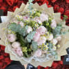 Bouquet of pale pink peonies with small white daisies and eucalyptus