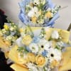A bright and refreshing hand-wrapped bouquet designed with a seasonal mix of