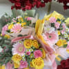 A fresh, spring-inspired hand-wrapped bouquet featuring a soft blend of yellow and