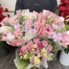 Florist choice, spring pink mix, features an assortment of seasonal florals wrapped