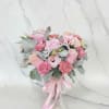 Blush Pink roses, lisianthus, and carnations in a decorative pink vase with
