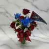 Deep red roses paired with vivid blue-dyed blooms and crisp white filler